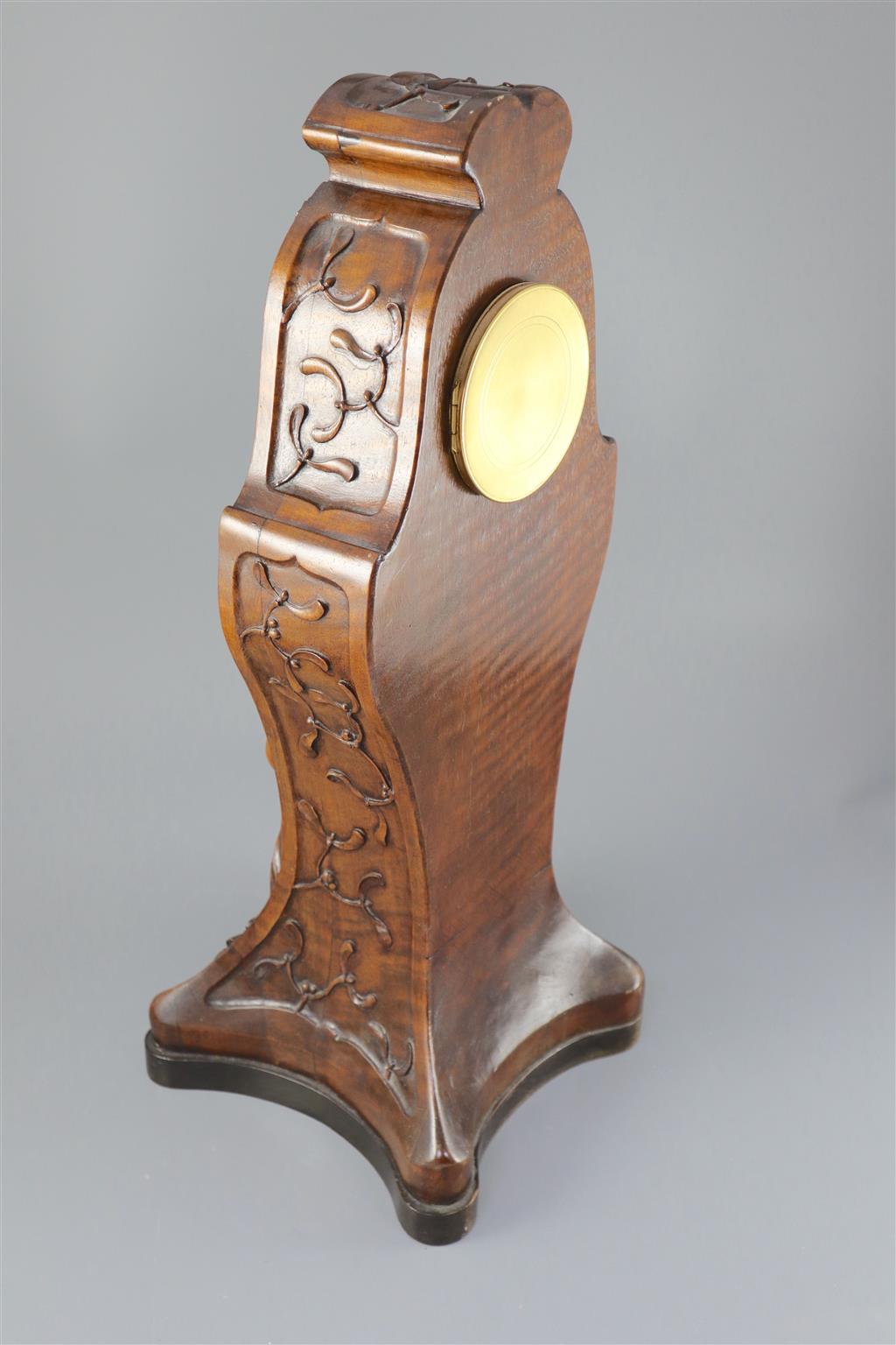 An unusual French Art Nouveau walnut mantel clock, width 9in. height 22.75in.
